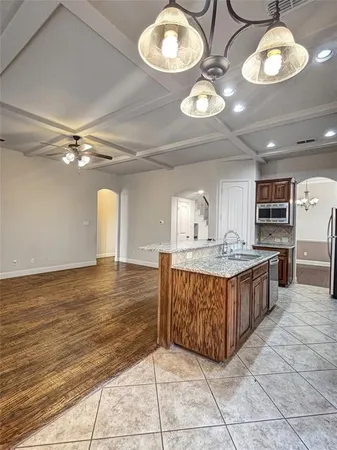 a kitchen with stainless steel appliances granite countertop a sink and cabinets