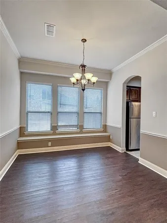 a view of room with wooden floor chandelier and window