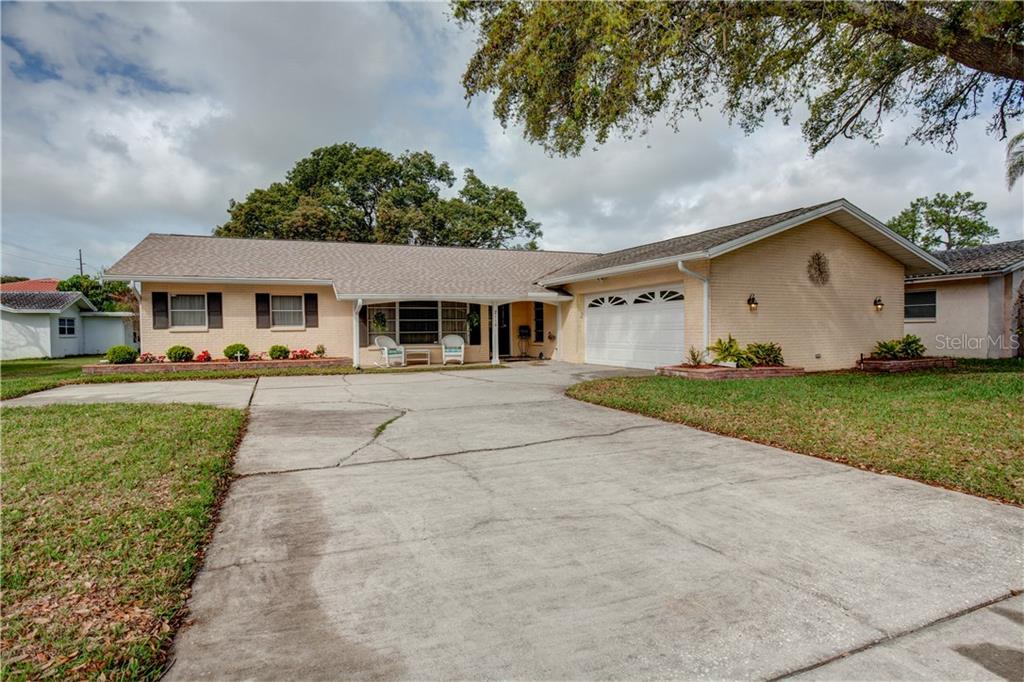 2110 Beecher Road North Clearwater, FL 33763 - Photo 1 of 1 a front view of a house with a yard