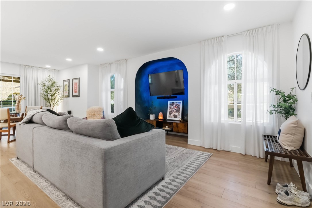 7950 West Flamingo Road, Unit 1180 Las Vegas, NV 89147 - Photo 5 of 26 Recessed lighting illuminates warm hardwood floors, enhancing the living space's inviting ambiance.