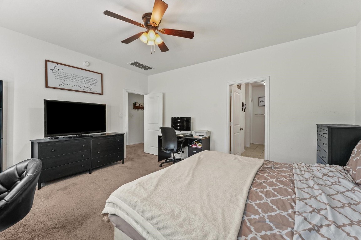 5303 Rivers Edge Drive Richmond, TX 77469 - Photo 19 of 26 a bedroom with a bed and a flat screen tv
