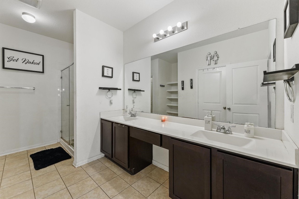 5303 Rivers Edge Drive Richmond, TX 77469 - Photo 20 of 26 a bathroom with a double vanity sink and mirror
