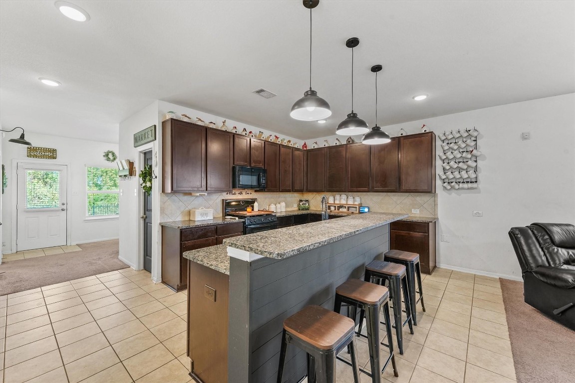 5303 Rivers Edge Drive Richmond, TX 77469 - Photo 8 of 26 a kitchen with stainless steel appliances kitchen island granite countertop a sink cabinets and wooden floor