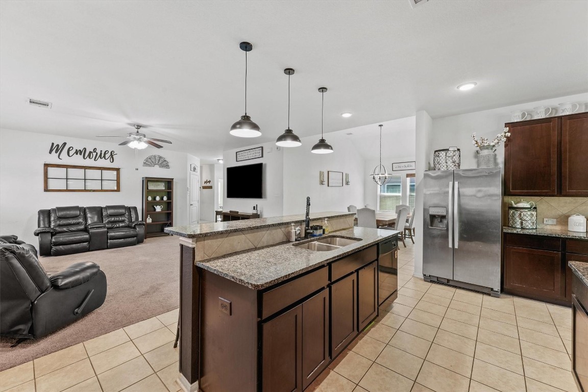 5303 Rivers Edge Drive Richmond, TX 77469 - Photo 9 of 26 a kitchen with stainless steel appliances granite countertop a sink and a refrigerator