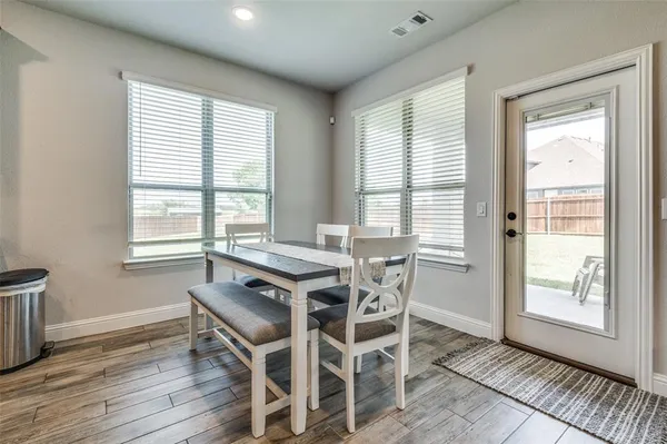 a dining room with furniture and windows