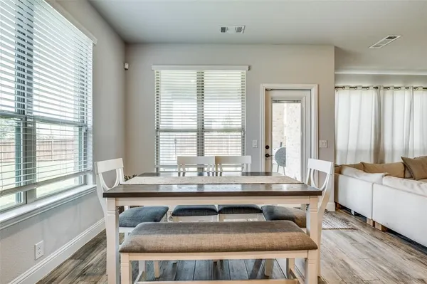 a dining table sitting next to a window