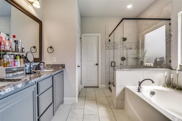 a bathroom with a tub sink and mirror