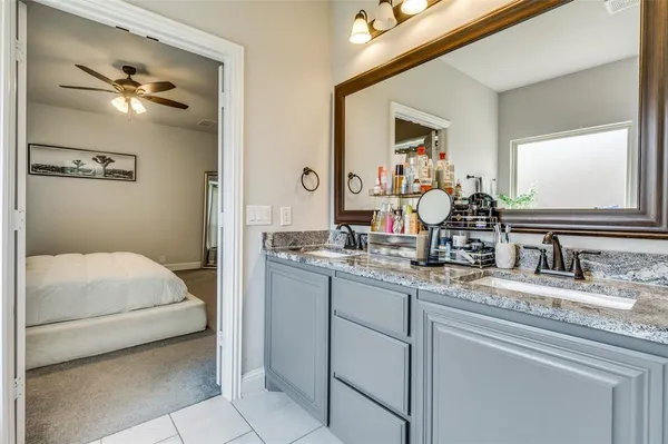 a en suite bathroom with a double vanity sink and a mirror