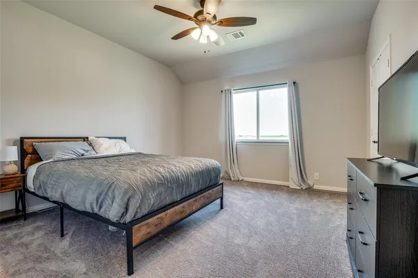 a bedroom with a bed and window