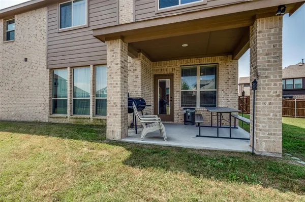 a view of a house with patio and yard