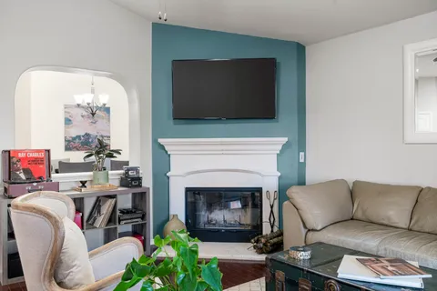 a kitchen with stainless steel appliances a refrigerator a stove a sink a dining table and chairs