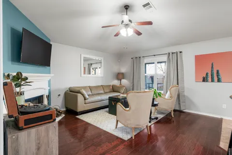 a kitchen with stainless steel appliances a dining table chairs microwave and sink