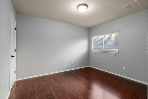 swimming pool with a table and chairs in front of house
