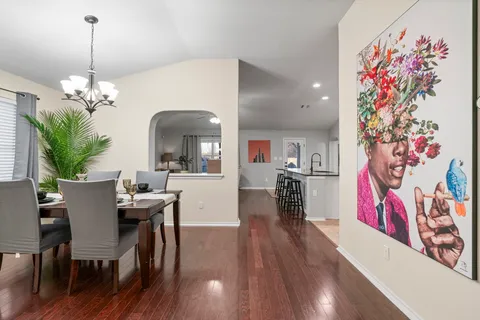 a view of a dining room with furniture and wooden floor
