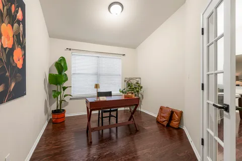 a view of a dining room with furniture a chandelier and wooden floor