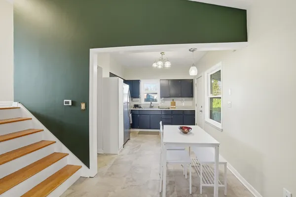 a view of kitchen with sink and refrigerator