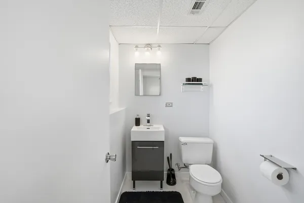 a bathroom with a sink mirror and toilet