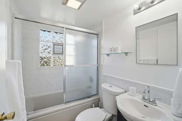 a bathroom with a sink toilet and shower