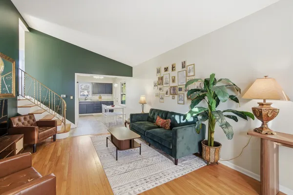 a living room with furniture and a potted plant