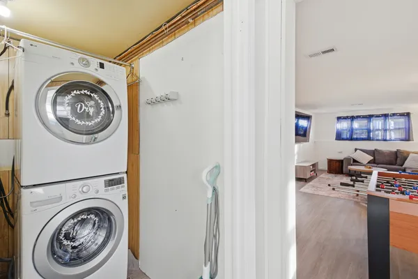 a view of a storage and utility room with washer and dryer