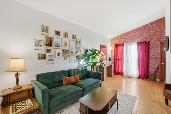 a living room with furniture a lamp and a window