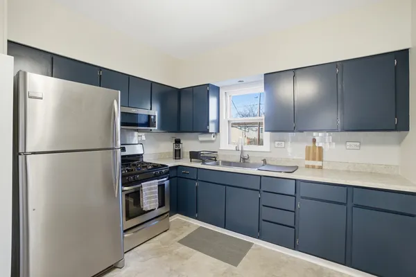 a kitchen with stainless steel appliances granite countertop a refrigerator stove a sink and dishwasher