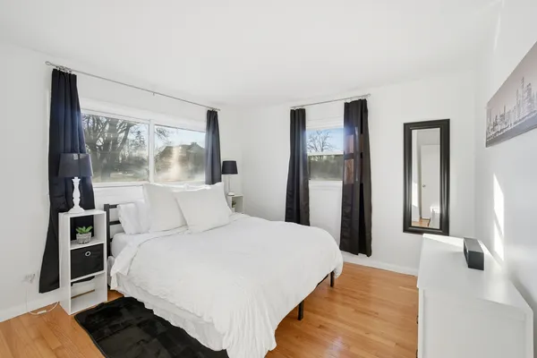 a bedroom with a large bed and a window