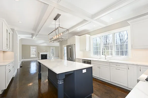 a large kitchen with kitchen island a sink stainless steel appliances and cabinets