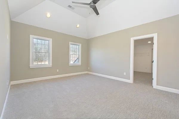 an empty room with windows and closet