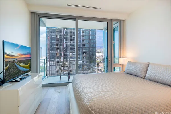 a bedroom with a large bed and a flat screen tv