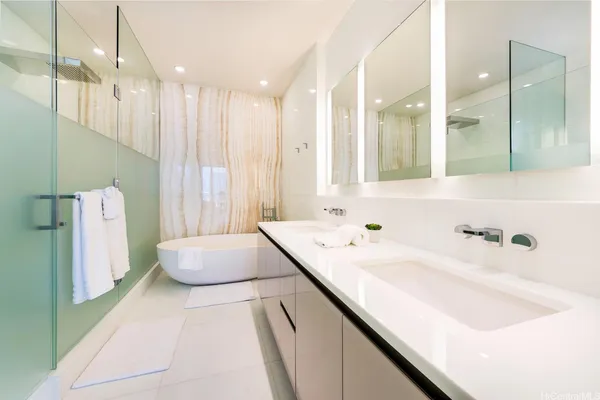 a bathroom with a bathtub sink and a mirror