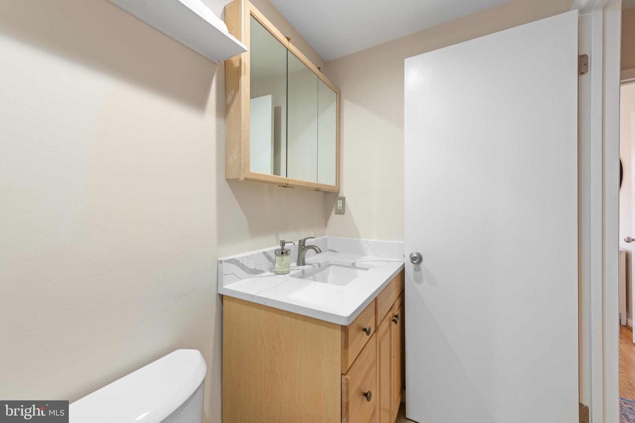 2012 O Street Northwest, Unit 22 Washington, DC 20036 - Photo 13 of 21 a bathroom with a sink a toilet and mirror