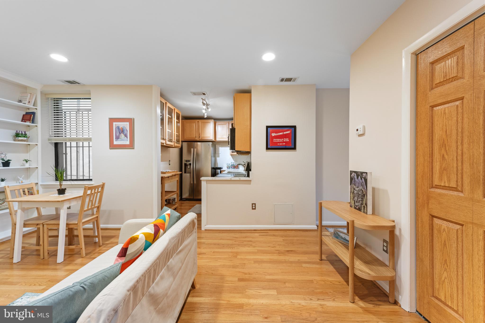 2012 O Street Northwest, Unit 22 Washington, DC 20036 - Photo 4 of 21 a room with furniture a flat screen tv and a refrigerator