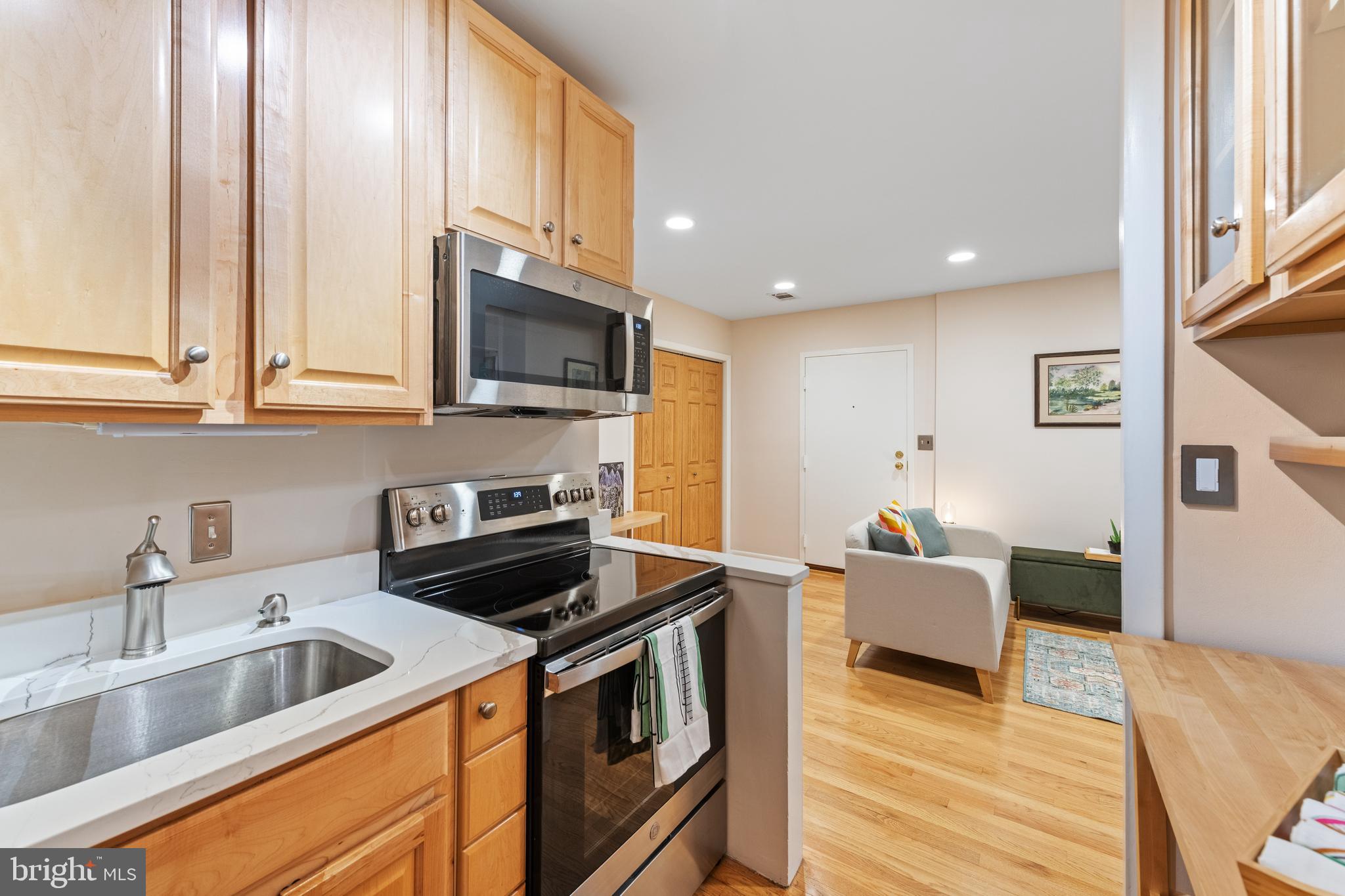 2012 O Street Northwest, Unit 22 Washington, DC 20036 - Photo 10 of 21 a kitchen with stainless steel appliances granite countertop a sink stove and refrigerator