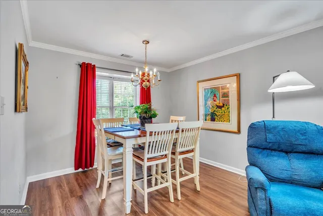a view of a dining room with furniture and chandelier