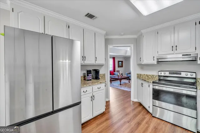 a kitchen with cabinets and stainless steel appliances