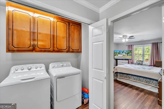 a bedroom with a bed a chair and a chandelier