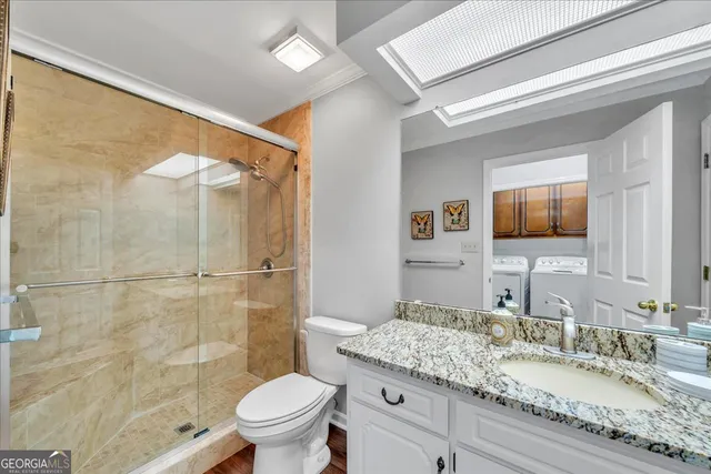 a living room with furniture flat screen tv and a large window