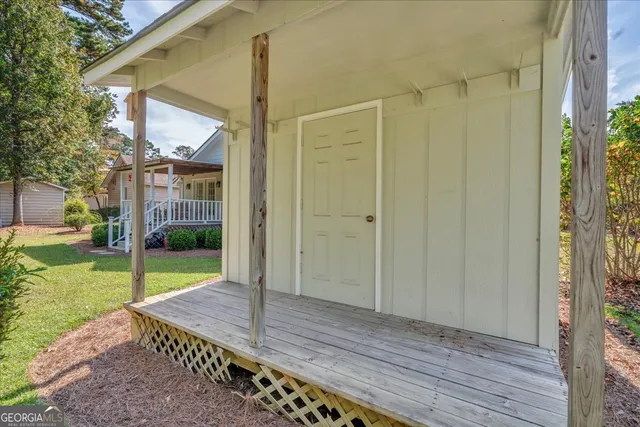 an aerial view of residential houses with outdoor space and trees