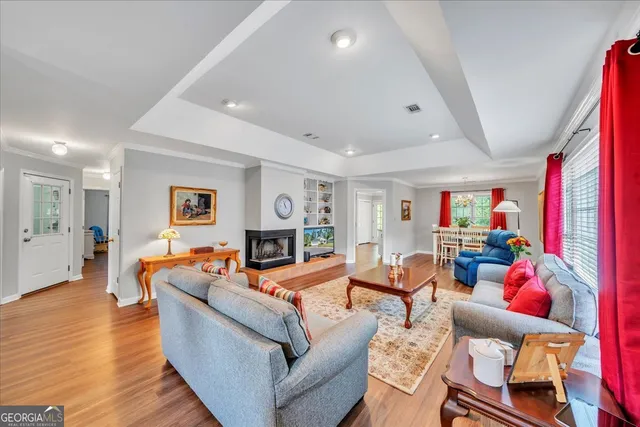 a living room with fireplace furniture and a wooden floor