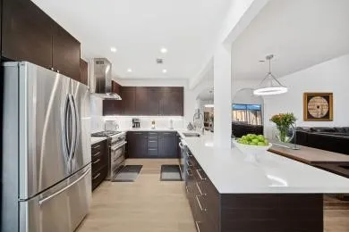 a kitchen with stainless steel appliances a refrigerator sink and stove