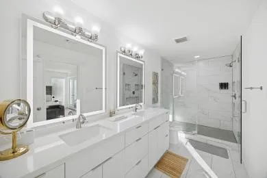 a bathroom with a double vanity sink mirror double and shower