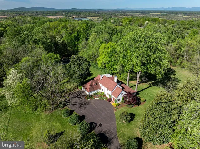 an aerial view of a house with yard