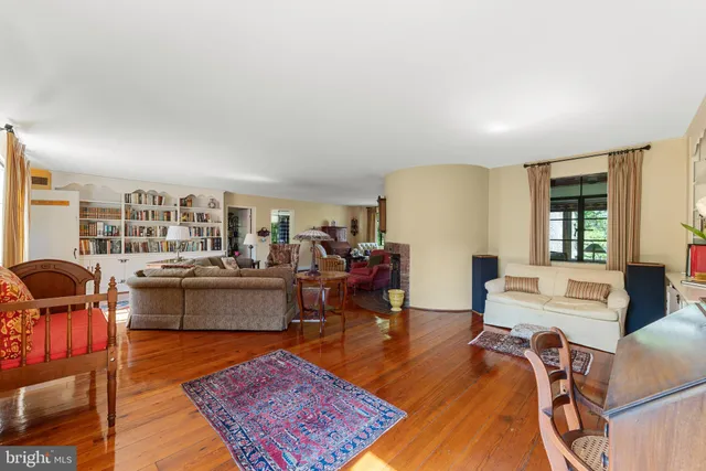 a living room with furniture a rug and a large window