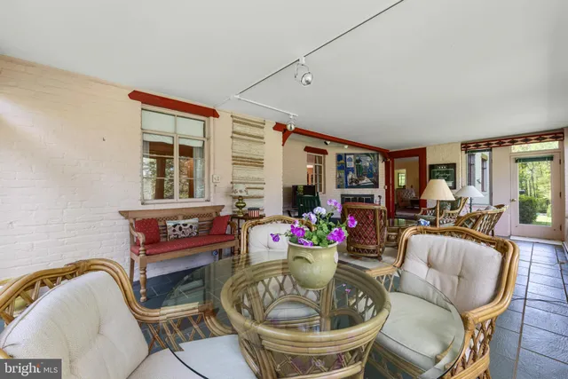 a living room with furniture flowerpot and window