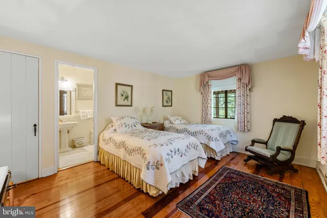 a bed room with a bed and chair