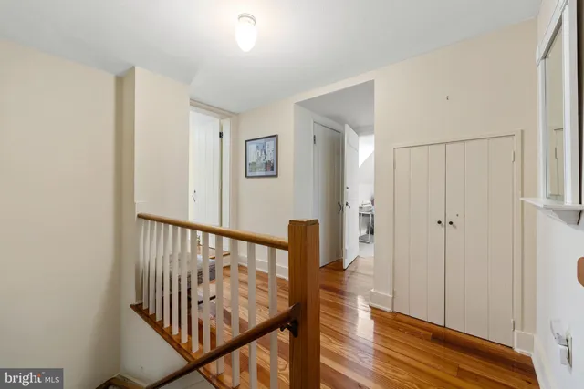 a view of a hallway with wooden floor and entryway