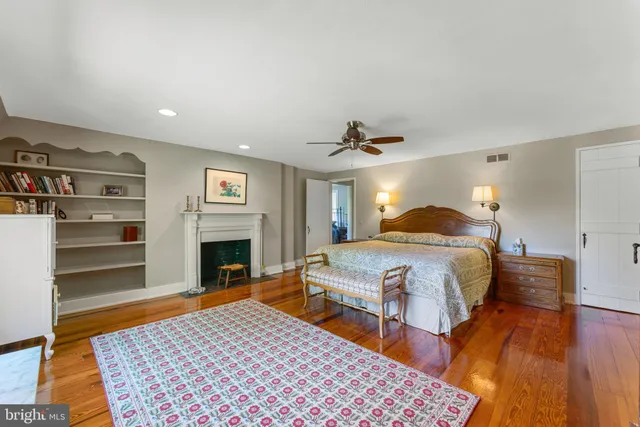 a bedroom with a bed and a fireplace