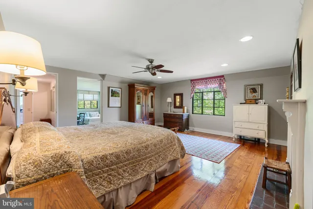 a bedroom with a large bed a flat tv screen and dresser