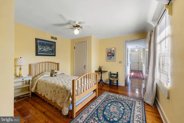 a bedroom with a bed and a book shelf